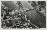 Aerial view of Flinders Street Station with the Yarra River, Princes Bridge and many commercial buildings, post-1930