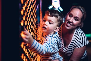 Woman and young child using interactive in the exhibition