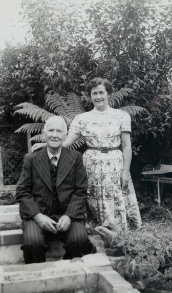 John Halliday (seated) with his daughter, Mrs Rita Lord (standing), in a leafy outdoor setting