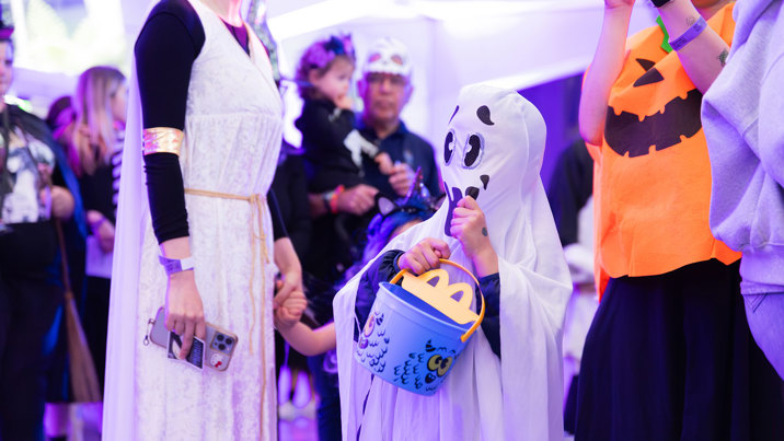 A child dressed as a ghost trick or treating during Halloween at the Museum.
