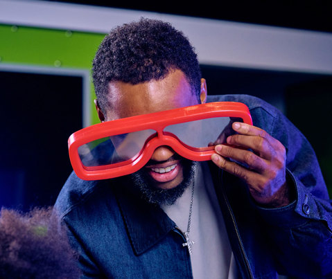A man using giant red glasses.