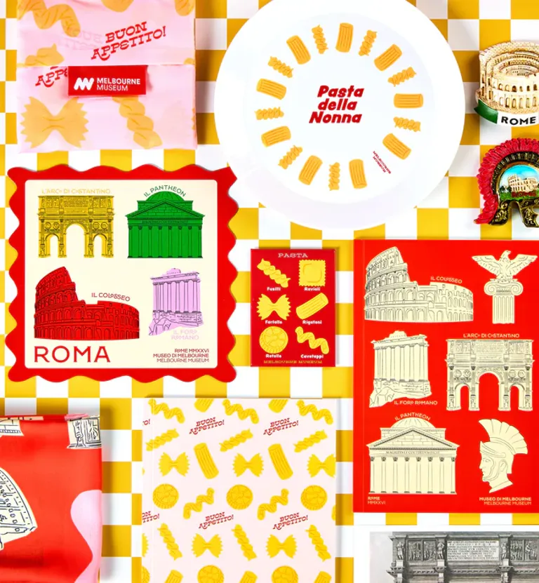 Flat lay image of shop products from the ROME exhibition collections, all products are yellows and reds