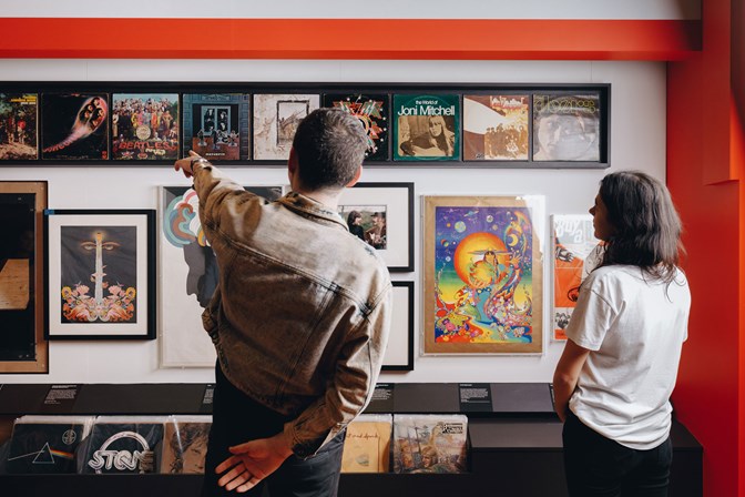Two people view a record collection