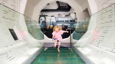 Girl running through a white tunnel