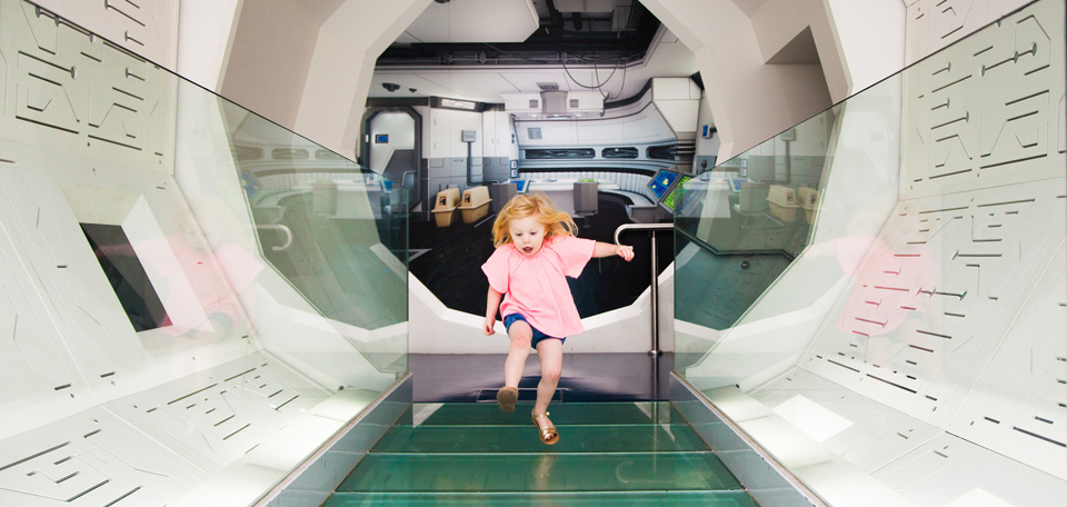 Girl running through a white tunnel