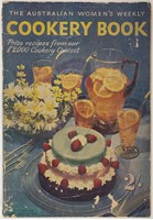 A cake, flowers and fruity drink on the cover of a faded magazine. 
