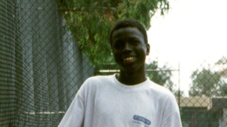 Sudanese teenager holding a basketball