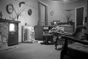 John Wilton Twycross watching television at 19 Plunkett Street, Brighton, circa 1950s.