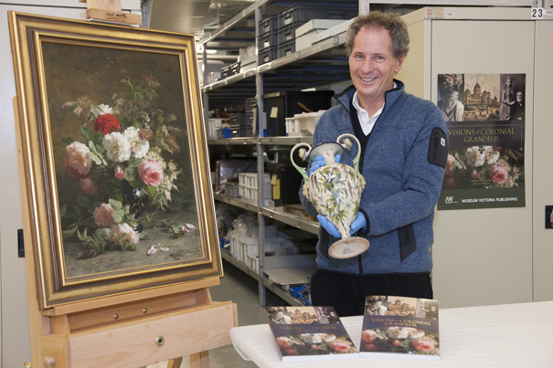 Will Twycross in Store E, Level 2, Melbourne Museum, with the publication 'Visions of Colonial Grandure' and objects from the Twycross Collection.