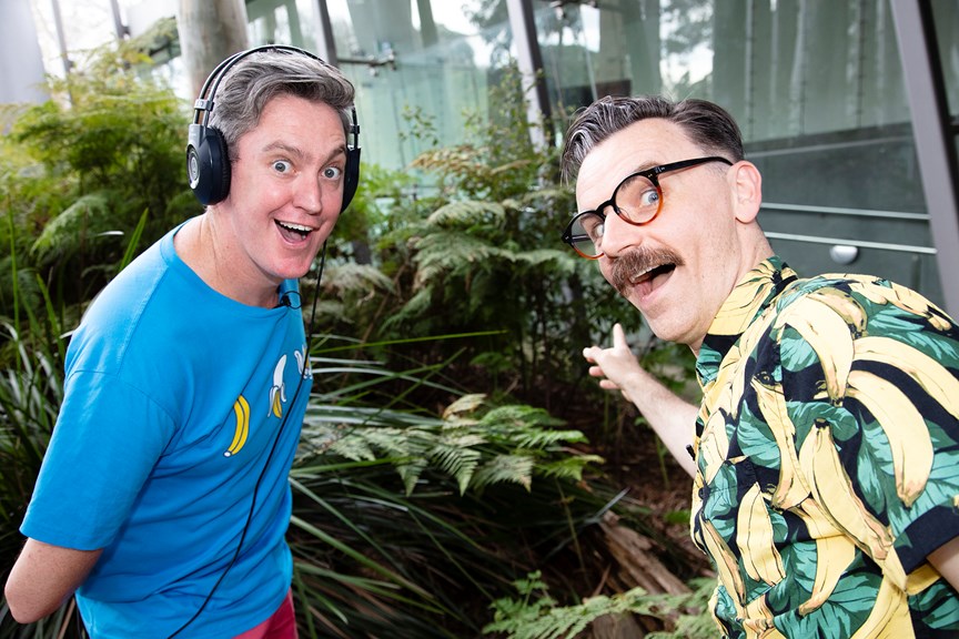 The Listies, comic duo Richard Higgins and Matt Kelly in Forest Gallery promoting their Melbourne Museum Audio Guide App. Matt is wearing headphones.