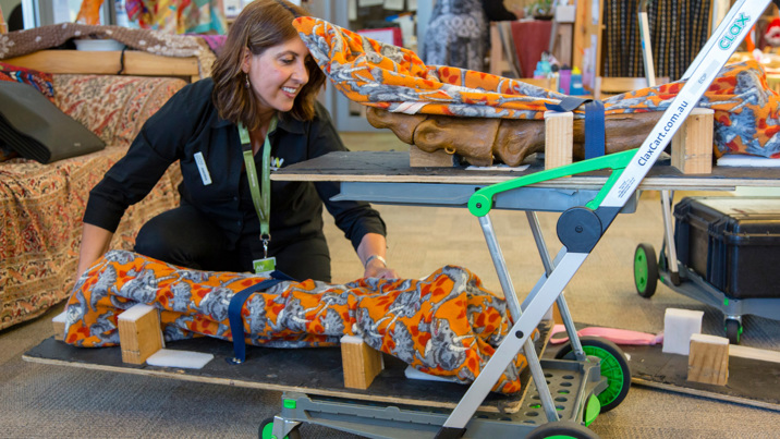 Outreach Program Presenter, loading specimens onto a trolley during a visit to a Child Care Centre. 