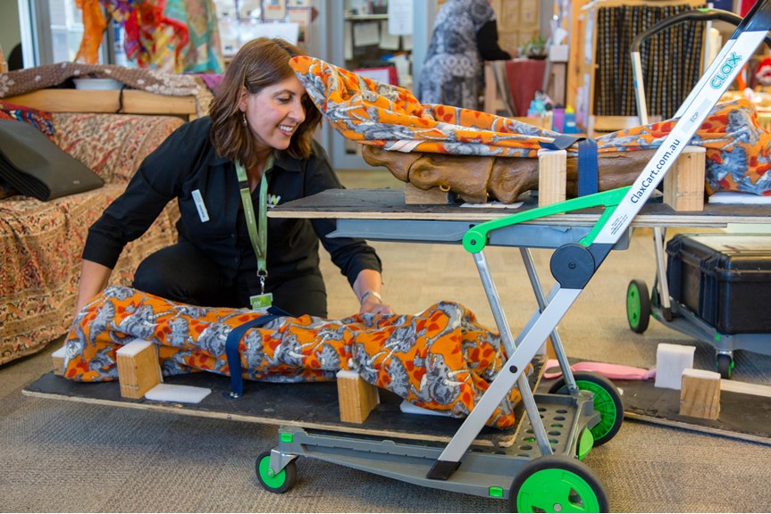 Outreach Program Presenter, loading specimens onto a trolley during a visit to a Child Care Centre. 