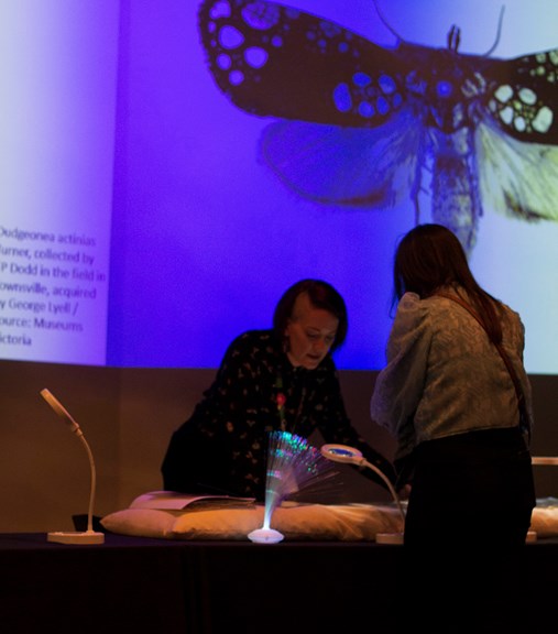 A museum staff member talks with a visitor at Melbourne Museum.