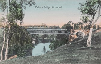 A steam suburban passenger train crossing the Hawthorn Bridge over the Yarra River, originally built by the Melbourne & Suburban Railway Co, circa 1900