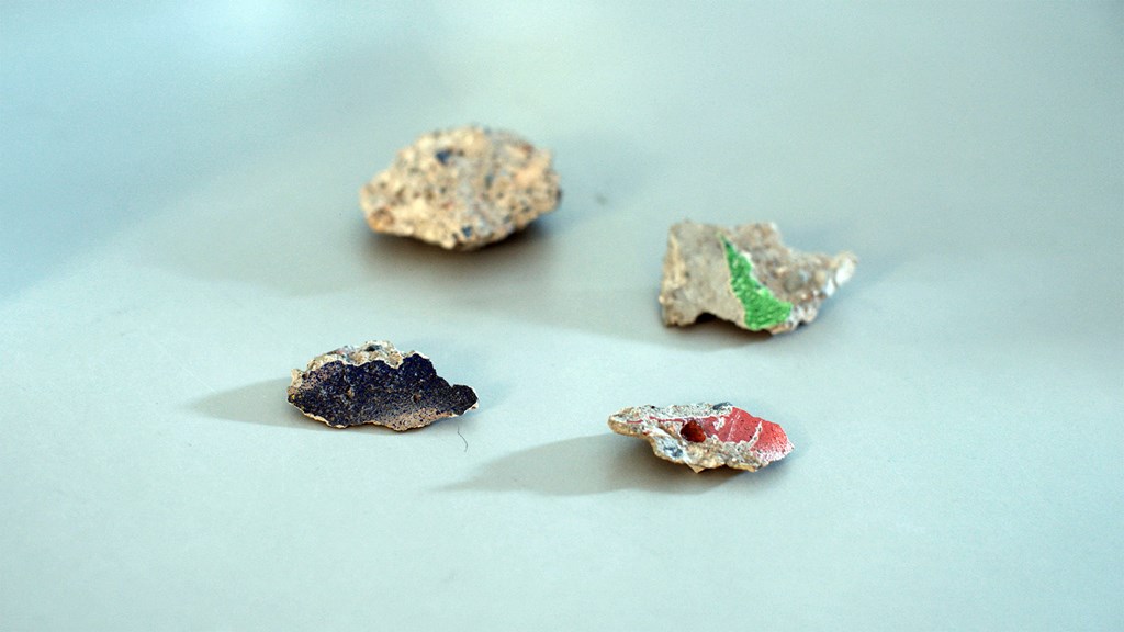 Small fragments of concrete flecked with paint. 
