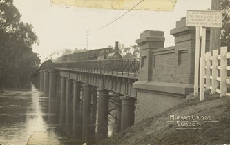 A steam locomotive hauling a mixed train crossing the Murray River, Echuca, pre-1906