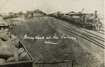 Trains passing through a station, circa 1910
