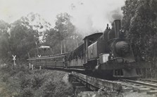 A steam locomotive hauling passenger carriages, circa 1920