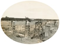 Scaffolding surrounds the brick-clad piers of the bridge over Emu Creek on the Gheringhap to Maroona line. Erection of girders, 1912