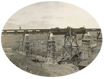 Scaffolding surrounds the brick-clad piers of the bridge over Emu Creek on the Gheringhap to Maroona line. Erection of girders, 1912