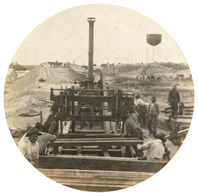 An adzing machine which appears to be on railway tracks. Railway construction, Mildura, circa 1908