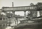 Construction of the rail bridge over the Murray River, Yarrawonga, circa 1930. A 100 foot girder is being moved into place on the piers.