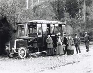 Victorian Railways no. 1 steam bus parked in front of a post and rail fence on the side of an unsealed forest range, Dandenong Ranges, circa 1901