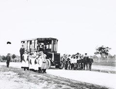Victorian Railways no. 1 steam bus parked on an unsealed rural road in undulating open farm country, circa 1901