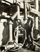 A man stands beside the hydraulic ejector pump which was used for draining water from the coffer dam during construction of the Mitchell River Bridge on the Bairnsdale to Orbost line, circa 1914.
