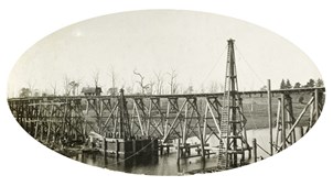 Bridge over the Nicholson River, Bairnsdale to Orbost line, circa 1915. A coffer dam is being used in the construction of Pier 4.