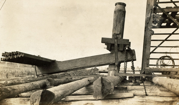 Bridge over the Nicholson River, Bairnsdale to Orbost line. A test pile loaded with a counter-levered dead weight of rails has been driven to a depth of 60 ft, circa 1912.