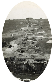 Construction of the Maribyrnong River Viaduct on the Albion to Broadmeadows line, Keilor East, 1928. Some of the concrete pedestals for the steel towers of the viaduct are in place and a tower at the far side has been constructed.