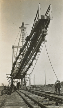 A travelling crane appears to be lifting a girder on the Maribyrnong River Viaduct on the Albion to Broadmeadows line, Keilor East, circa 1928-29.