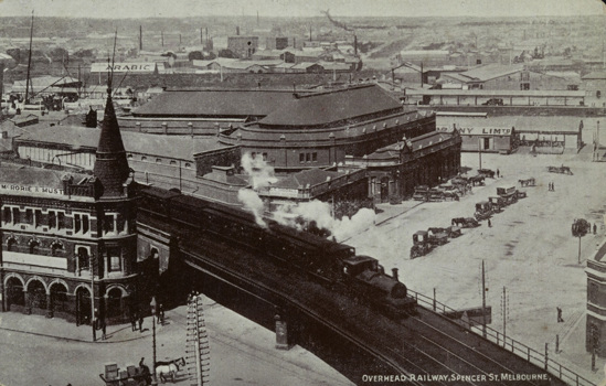 A steam locomotive hauling a passenger train, crossing Flinders Street Viaduct, circa 1910