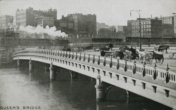 A steam train crossing Flinders Street Viaduct, circa 1910