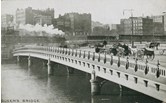 A steam train crossing Flinders Street Viaduct, circa 1910