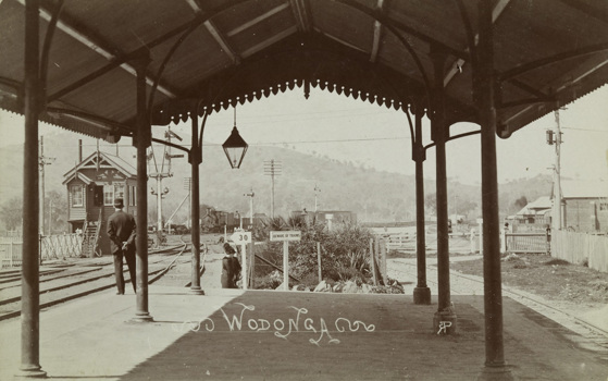 A guard stands on the platform of Wodonga Railway Station as a train approaches, circa 1910