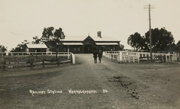 Two gentlemen walking towards the main entrance of Warracknabeal Railway Station, circa 1915