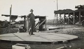 A worker standing on the base of a 24,000 gallon welded tank, Balranald, 1927. Balranald was the last station on the Moama to Balranald line.