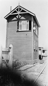 Signalman sitting in signal box window, Mentone Railway Station, pre-1930