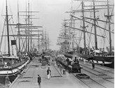 Sailing ships and steam train at Sandridge Pier, Port Melbourne, circa 1880