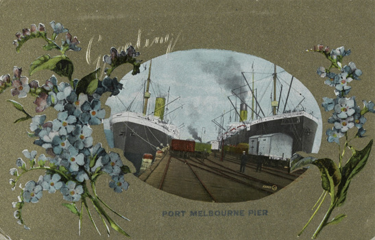 Rail trucks and two large ships berthed at Railway Pier (Station Pier), Port Melbourne, pre-December 1907. This is a greeting card with sprays of flowers on either side of the image.