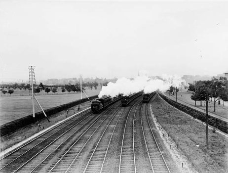 Three E class steam locomotives (nos. 504, 492 and 486) hauling suburban passenger trains bound variously for Sandringham, Oakleigh and Box Hill