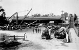 Loading logs onto a train in the Traralgon railway yard, circa 1920