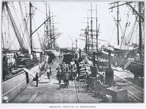 Loaded bagged wheat for export from rail trucks into sailing ships, Williamstown Pier, circa 1900. Draft horses are being used to shunt the railway trucks on the pier.