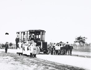 Victorian Railways no. 1 steam bus, parked on an unsealed rural road in undulating open farm country, circa 1901