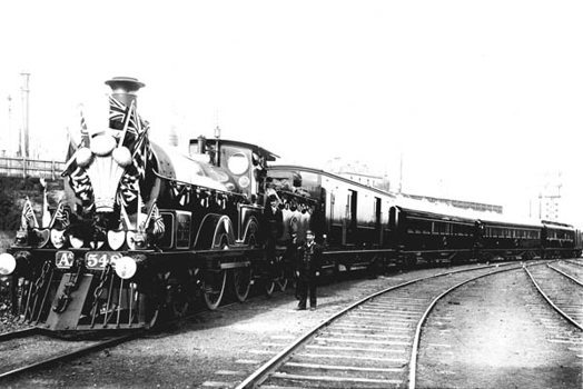AA class steam locomotive no. 548 decorated for a visit by the Duke and Duchess of Cornwall and York, in the Spencer Street rail yard, May 1901