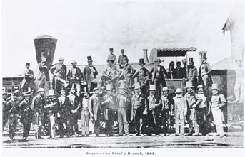 Group of 35 engineers and clerical staff from the Engineer-in-Chief's Branch of the Victorian Railways Department posing in front of one of the government railway's early Beyer Peacock 0-2-0 passenger locomotives, circa 1862