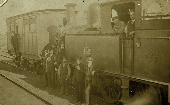 Loco crew with passengers and staff, circa 1910