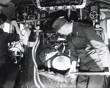Loco crew driving and firing a Victorian Railways locomotive at North Melbourne Loco Depot, circa 1950